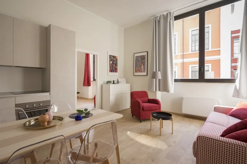 A bright apartment with a living area and kitchenette